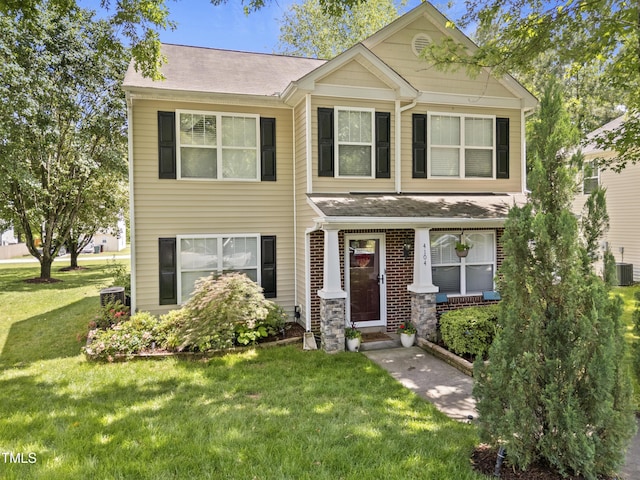 view of front of property with a front yard, roof with shingles, and central air condition unit