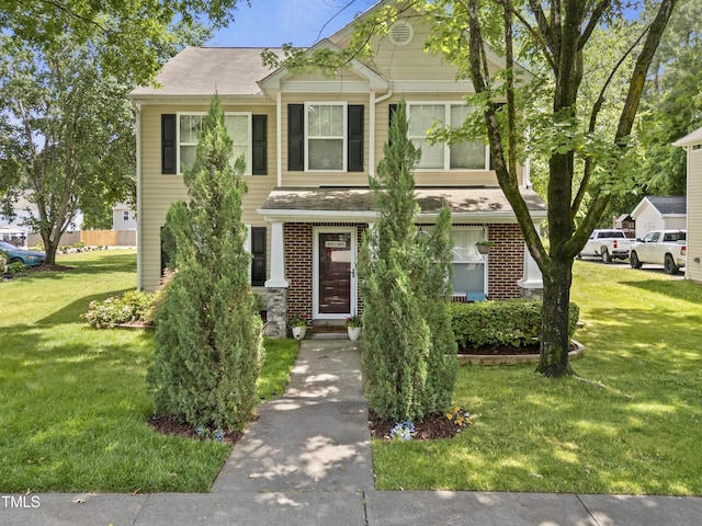 traditional-style house with a front yard, brick siding, and a shingled roof