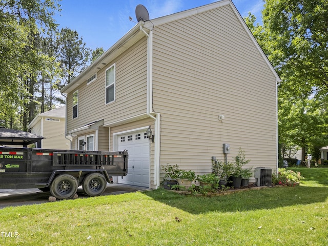 view of side of property with a garage, central air condition unit, and a lawn