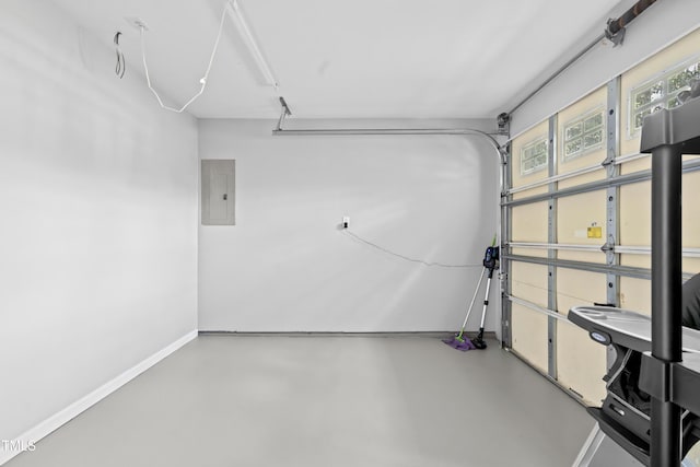 garage featuring electric panel and baseboards