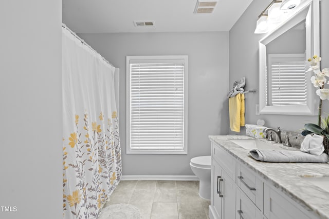 full bath featuring toilet, vanity, baseboards, and tile patterned floors