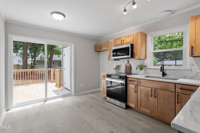 3700 Summer Pl, Raleigh, NC 27604 - kitchen with stainless steel microwave, black range with electric stovetop, a sink, healthy amount of natural light, and crown molding