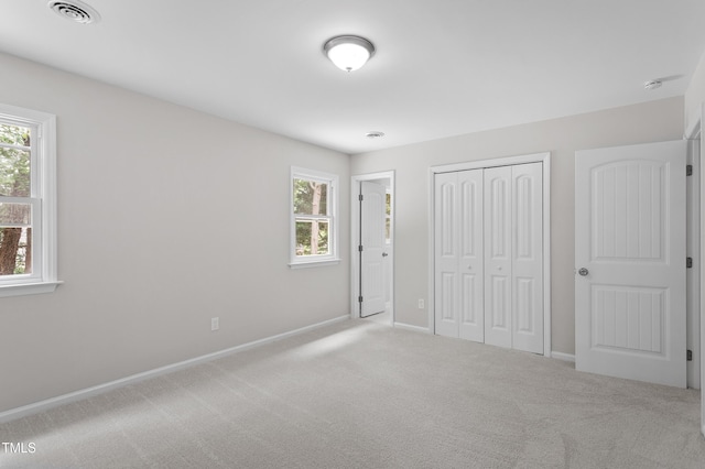 3700 Summer Pl, Raleigh, NC 27604 - unfurnished bedroom with multiple windows, carpet flooring, and baseboards