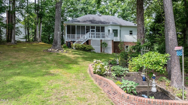 204 Muirfield Ln, Clayton, NC 27527 - view of front of home with a sunroom, a front lawn, stairway, and a shingled roof