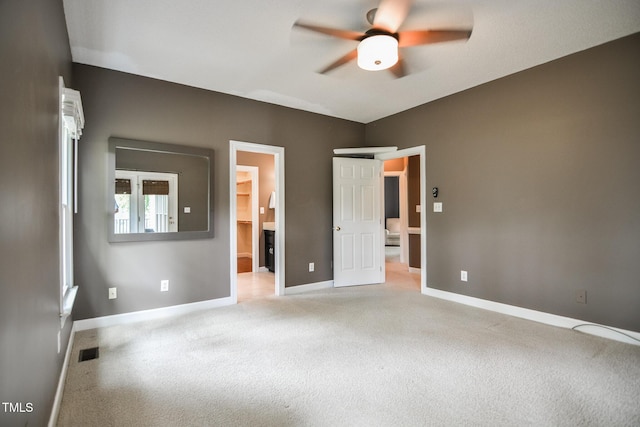 204 Muirfield Ln, Clayton, NC 27527 - unfurnished bedroom with light carpet, baseboards, ensuite bath, and a ceiling fan