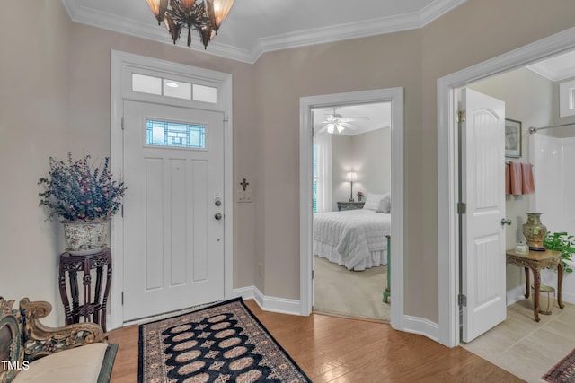 79 Heatherwood Dr, Chapel Hill, NC 27516 - entryway with crown molding, baseboards, light wood-style floors, and a chandelier