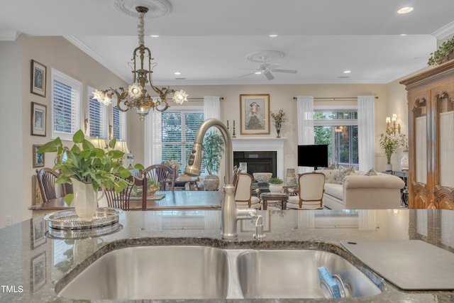 79 Heatherwood Dr, Chapel Hill, NC 27516 - detailed view of a sink, ceiling fan, a glass covered fireplace, ornamental molding, and recessed lighting