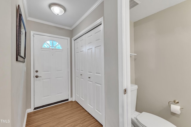 134 Riverwalk Cir, Cary, NC 27511 - foyer entrance featuring light wood finished floors, crown molding, and baseboards