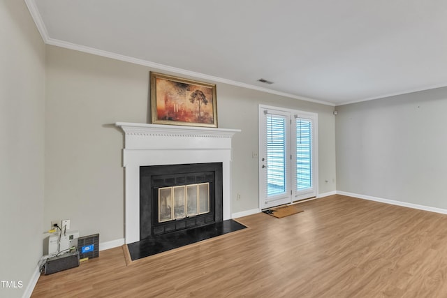 134 Riverwalk Cir, Cary, NC 27511 - unfurnished living room featuring wood finished floors, crown molding, a fireplace with flush hearth, and baseboards