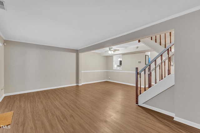 134 Riverwalk Cir, Cary, NC 27511 - unfurnished living room with wood finished floors, baseboards, ornamental molding, stairs, and a ceiling fan