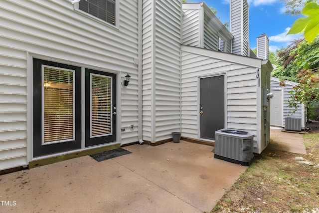 134 Riverwalk Cir, Cary, NC 27511 - property entrance with a patio area, a chimney, and central air condition unit