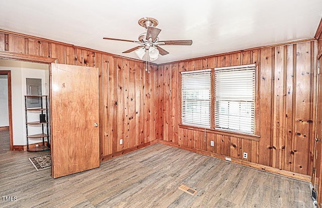 3301 Amherst Rd, Rocky Mount, NC 27804 - unfurnished room with a ceiling fan, wood finished floors, baseboards, and wooden walls