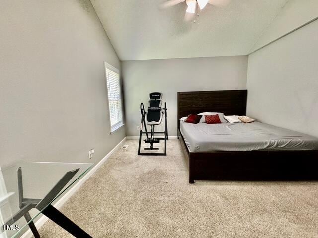 carpeted bedroom featuring lofted ceiling, baseboards, and ceiling fan