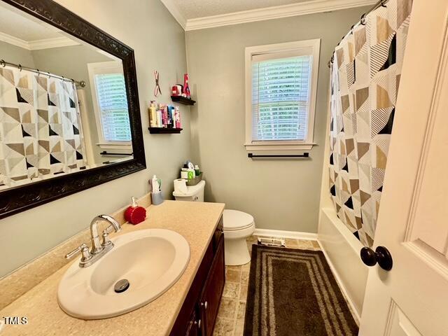 bathroom featuring ornamental molding, vanity, toilet, and tile patterned flooring