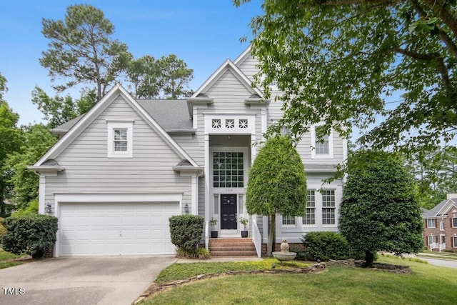 100 Wentbridge Rd, Cary, NC 27519 - view of front facade with concrete driveway, a garage, and a front lawn