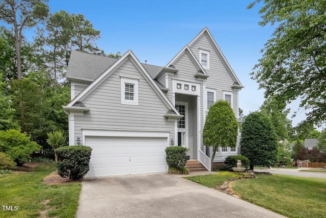 100 Wentbridge Rd, Cary, NC 27519 - view of front facade featuring concrete driveway, an attached garage, and a front yard