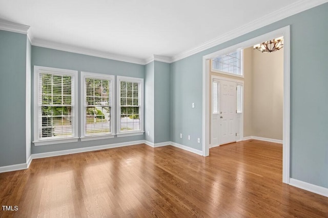 100 Wentbridge Rd, Cary, NC 27519 - empty room with a chandelier, baseboards, wood finished floors, and crown molding