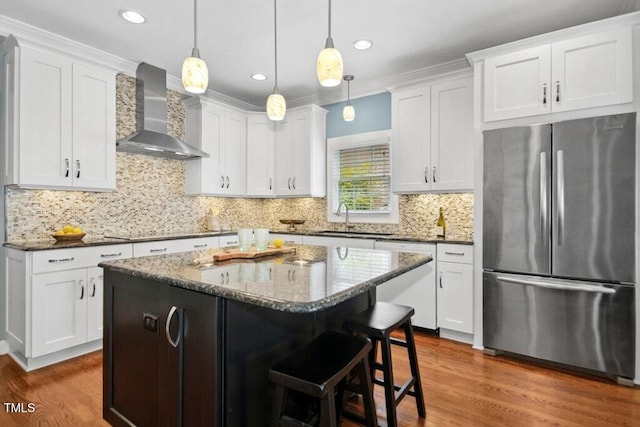 100 Wentbridge Rd, Cary, NC 27519 - kitchen with freestanding refrigerator, wall chimney exhaust hood, a sink, dishwasher, and wood finished floors