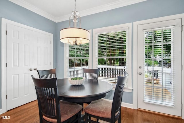 100 Wentbridge Rd, Cary, NC 27519 - dining area with wood finished floors, ornamental molding, a chandelier, and baseboards