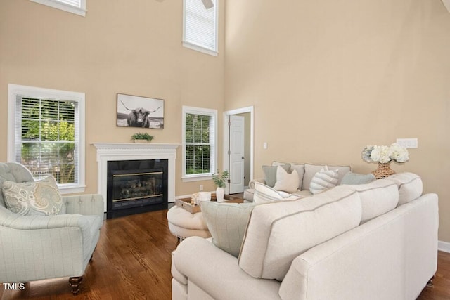 100 Wentbridge Rd, Cary, NC 27519 - living area with plenty of natural light, dark wood finished floors, a fireplace with flush hearth, and a high ceiling