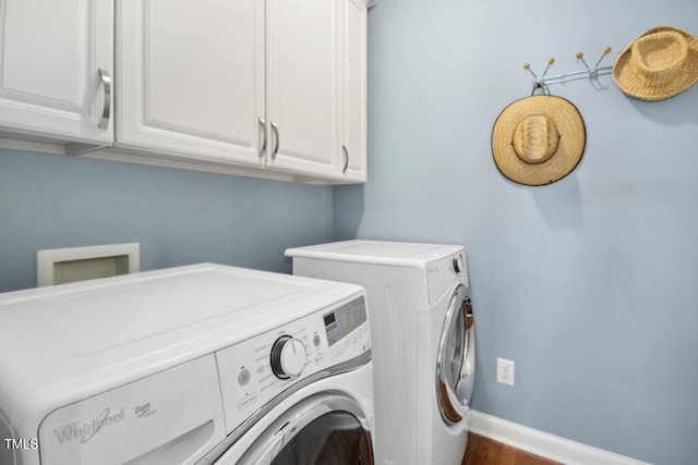 100 Wentbridge Rd, Cary, NC 27519 - washroom with washing machine and clothes dryer, cabinet space, baseboards, and wood finished floors