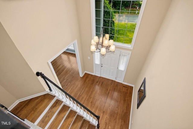 100 Wentbridge Rd, Cary, NC 27519 - entrance foyer with wood finished floors, a chandelier, baseboards, a towering ceiling, and stairs