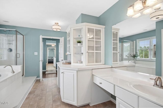 100 Wentbridge Rd, Cary, NC 27519 - full bathroom featuring a shower stall, a bath, vanity, ensuite bathroom, and baseboards
