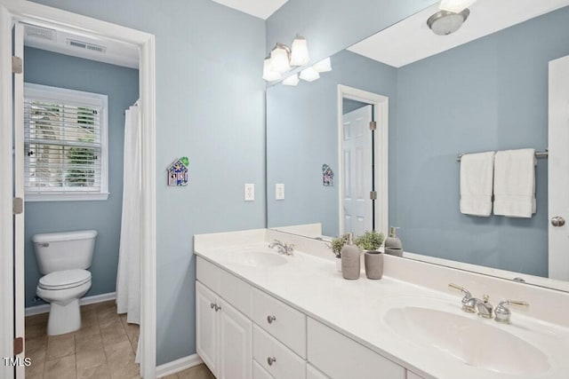100 Wentbridge Rd, Cary, NC 27519 - full bathroom featuring toilet, double vanity, and baseboards