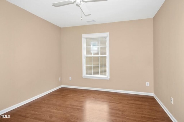 100 Wentbridge Rd, Cary, NC 27519 - spare room with dark wood-type flooring, a ceiling fan, and baseboards