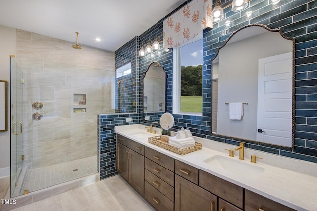 bathroom featuring a shower stall, double vanity, tile walls, and recessed lighting