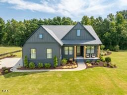 view of front of house featuring a porch and a front yard