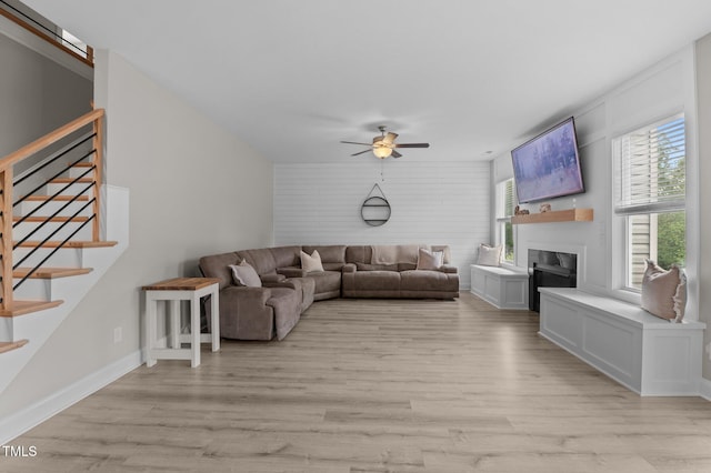 55 Prospectus Ln, Franklinton, NC 27525 - living room featuring light wood-type flooring, stairs, ceiling fan, and a fireplace