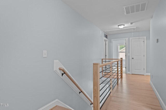 55 Prospectus Ln, Franklinton, NC 27525 - hallway with an upstairs landing, attic access, baseboards, and light wood-style floors