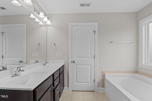55 Prospectus Ln, Franklinton, NC 27525 - bathroom featuring tile patterned flooring, a bath, double vanity, and baseboards
