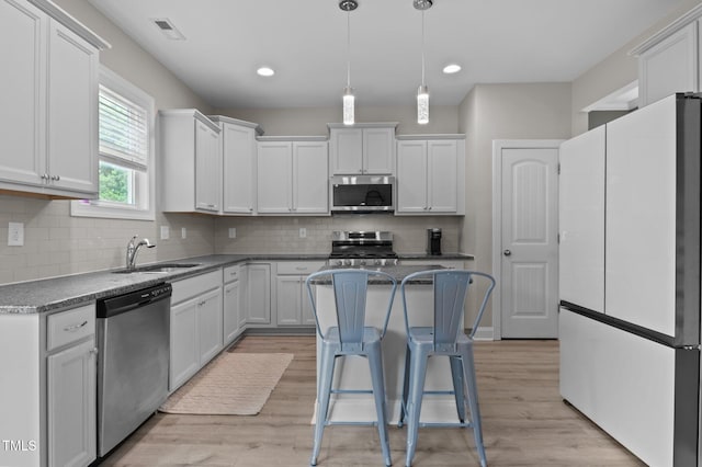 55 Prospectus Ln, Franklinton, NC 27525 - kitchen featuring stainless steel appliances, a sink, white cabinets, light wood-type flooring, and recessed lighting