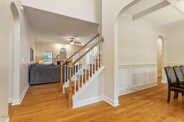 68 Tanners Way, Clayton, NC 27527 - stairway featuring arched walkways, a ceiling fan, wood finished floors, and crown molding