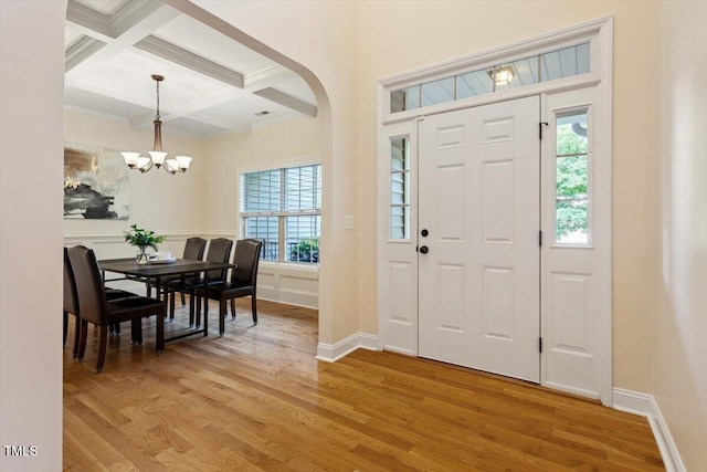 68 Tanners Way, Clayton, NC 27527 - foyer entrance featuring beamed ceiling, light wood-type flooring, crown molding, a chandelier, and coffered ceiling