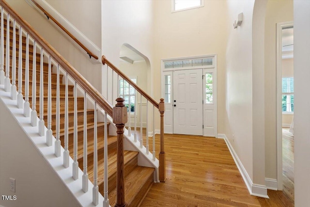68 Tanners Way, Clayton, NC 27527 - entryway featuring a high ceiling, plenty of natural light, arched walkways, and light wood finished floors