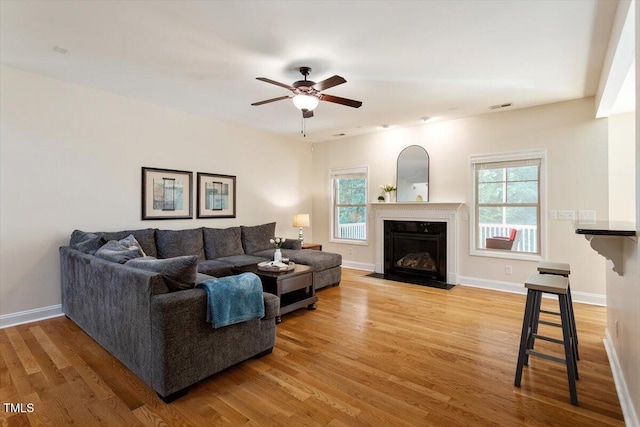 68 Tanners Way, Clayton, NC 27527 - living area featuring light wood-style flooring, a fireplace with flush hearth, ceiling fan, and baseboards