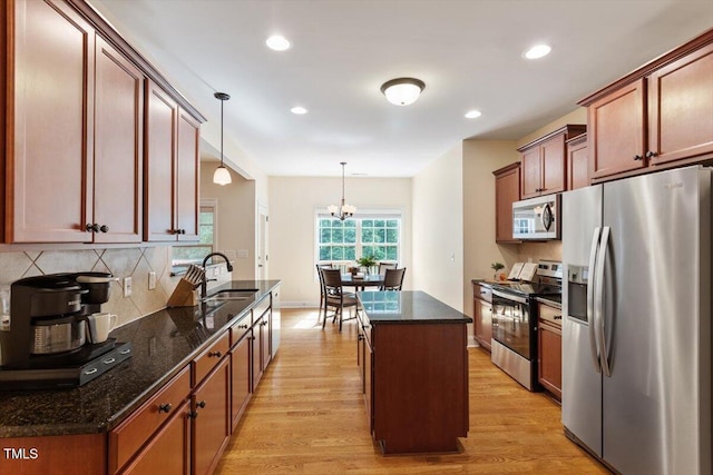 68 Tanners Way, Clayton, NC 27527 - kitchen with appliances with stainless steel finishes, light wood-style flooring, decorative backsplash, a sink, and recessed lighting