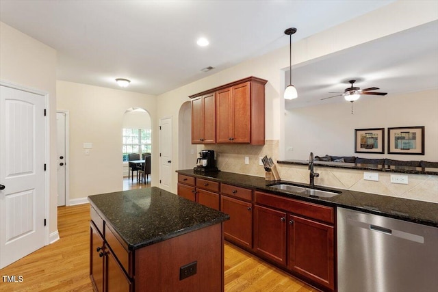 68 Tanners Way, Clayton, NC 27527 - kitchen with stainless steel dishwasher, a sink, arched walkways, ceiling fan, and backsplash