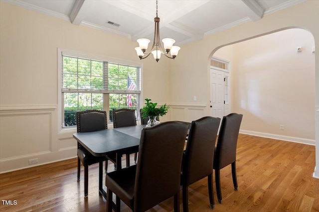 68 Tanners Way, Clayton, NC 27527 - dining area featuring arched walkways, coffered ceiling, a chandelier, wood finished floors, and beam ceiling