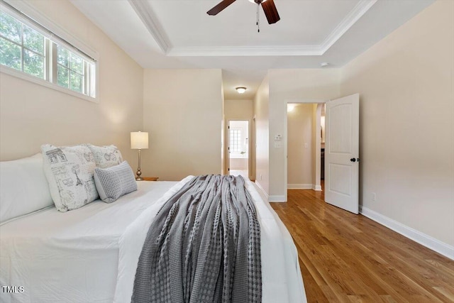 68 Tanners Way, Clayton, NC 27527 - bedroom featuring wood finished floors, a tray ceiling, ornamental molding, baseboards, and ensuite bathroom
