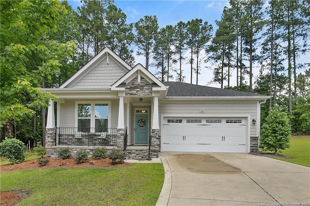 craftsman-style home featuring stone siding, a garage, concrete driveway, a front yard, and a porch