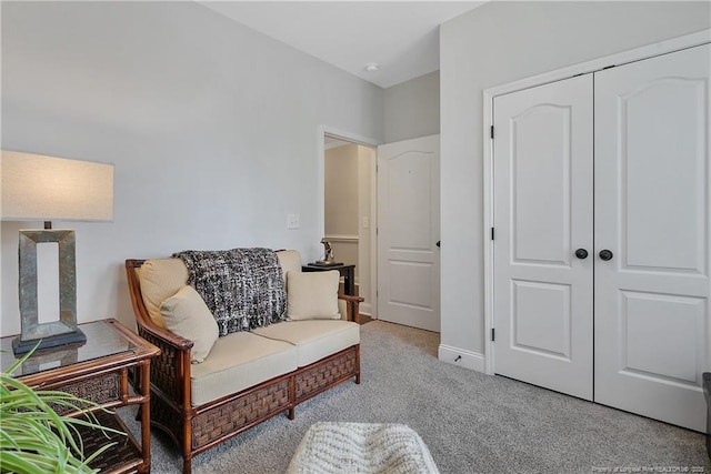 sitting room featuring carpet flooring and baseboards
