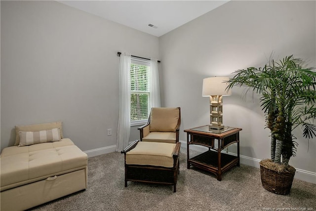 living area featuring carpet floors and baseboards