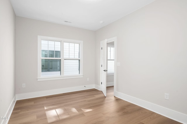 703 E Markham Ave, Durham, NC 27701 - unfurnished room with light wood finished floors and baseboards