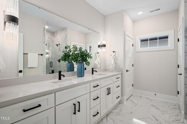 703 E Markham Ave, Durham, NC 27701 - bathroom with double vanity, a marble finish shower, recessed lighting, and marble finish floors