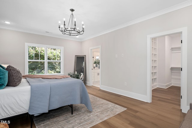 703 E Markham Ave, Durham, NC 27701 - bedroom featuring a chandelier, ornamental molding, wood finished floors, recessed lighting, and a walk in closet