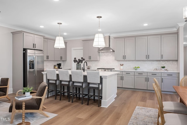 703 E Markham Ave, Durham, NC 27701 - kitchen featuring stainless steel fridge with ice dispenser, wall chimney range hood, gray cabinetry, light countertops, and crown molding